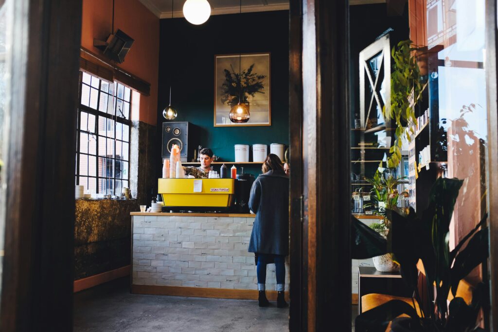 Staff serving a customer at a café counter in Auckland, New Zealand